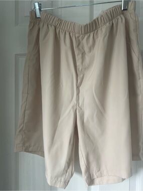 MANFINITY XL Black Satin Size Tag on Light Beige Fabric